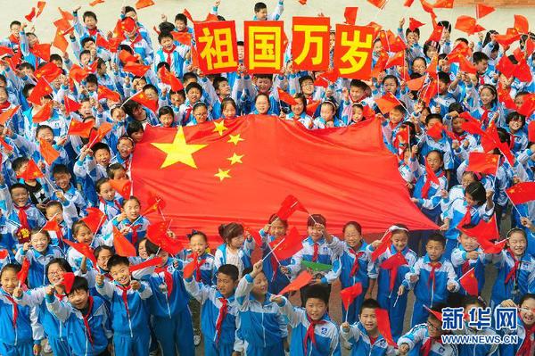 9月26日，安徽省阜陽市北城小學分校的學生與國旗合影。新華社發(fā)（王彪 攝）