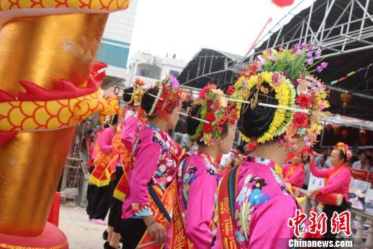 6月2日，福建泉州蟳浦媽祖宮廟——順濟宮重修落成慶典儀式舉行，蟳埔女頭上戴著鮮花串成的“簪花圍”成了“移動的花海”?！×戊o 攝
