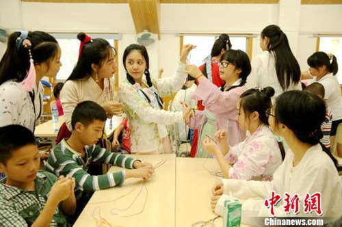 資料圖：桂林漢服愛好者舉辦“端午雅集”活動，現(xiàn)場教學編織五彩繩。裴蕾 攝