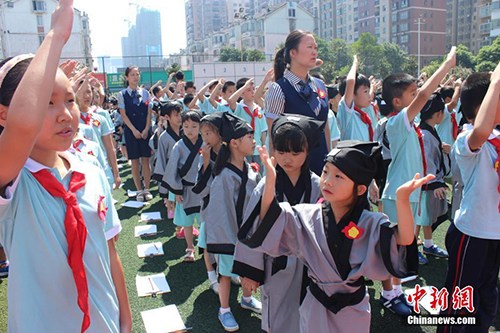 　　8月29日，長沙市岳麓區(qū)一小學舉行開學典禮，一年級新生們身著漢服，在老師的帶領和高年級同學的幫助下完成了“開筆禮”。校方希望以此方式教育學生從小要立志、做好人，學會感恩老師，勇于表達。劉著之 攝