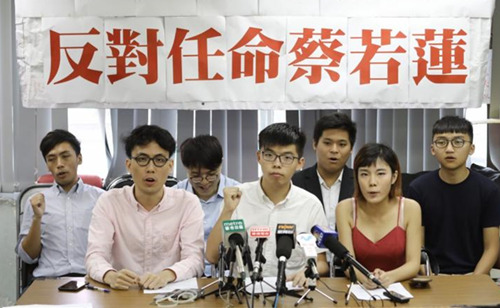 (前左起)港語學(xué)召集人陳樂行、香港眾志秘書長黃之鋒、教育實(shí)驗(yàn)學(xué)社傳媒聯(lián)絡(luò)人黃子悅高叫“副局夢圓，教育玩完”口號。_副本.jpg