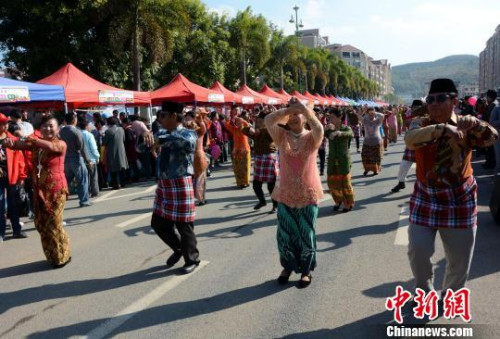 踩街隊(duì)伍在美食街上穿行表演，整個(gè)活動(dòng)現(xiàn)場成為歌舞的海洋?！埥鸫āz