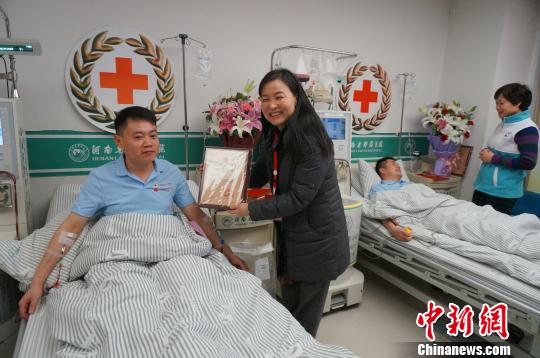 圖為河南省紅十字會(huì)領(lǐng)導(dǎo)向兩名捐獻(xiàn)志愿者頒發(fā)榮譽(yù)證書。　韓章云 攝