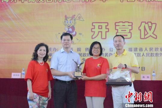 中國(guó)僑網(wǎng)7月9日，2018年海外華裔及臺(tái)灣地區(qū)青少年“中國(guó)尋根之旅”夏令營(yíng)——福建洛江營(yíng)開(kāi)營(yíng)式上，主辦方互贈(zèng)紀(jì)念品?！O虹　攝