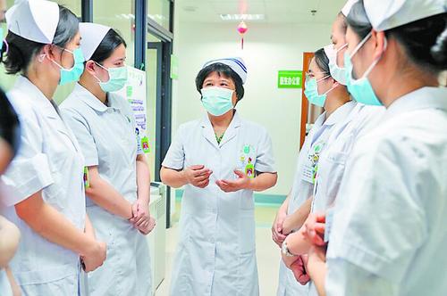 住桂全國政協(xié)委員、南寧市第四人民醫(yī)院艾滋病科護(hù)士長杜麗群，主動申請前往抗疫一線。圖為杜麗群在給年輕護(hù)士們傳授經(jīng)驗。